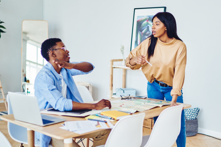 Young couple of freelancers discussing project at home