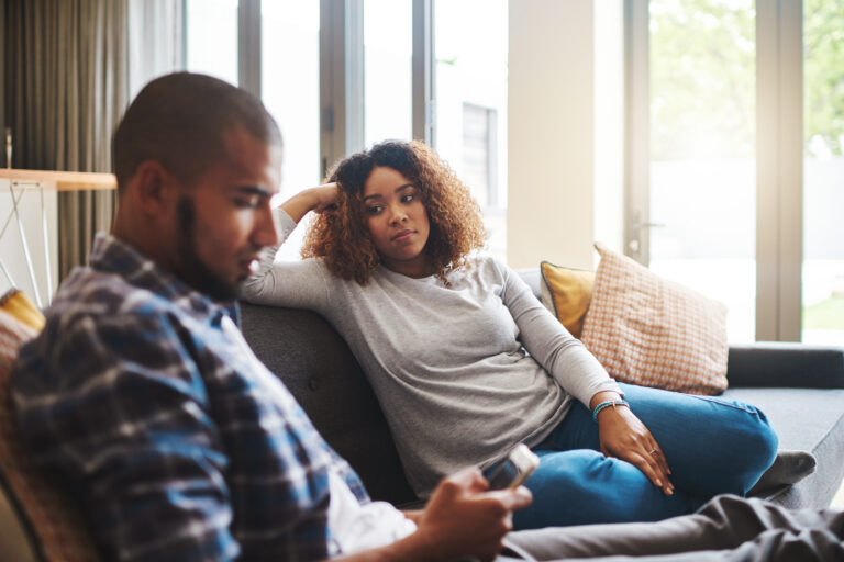 Couple, separation or fight with argument on sofa for disagreement, conflict or living room dispute at home