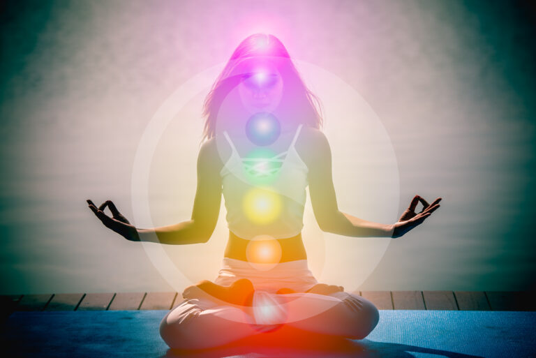 Young woman in yoga meditation with seven chakras and Yin Yang symbols