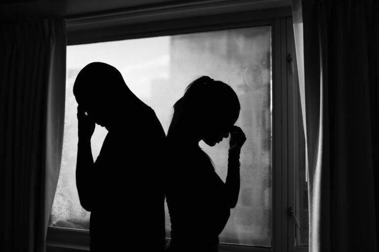 Young Couple Arguing and Fighting. Domestic Violence and Emotional abuse Scene, Stressed Woman in a Dark Hallway of Apartment