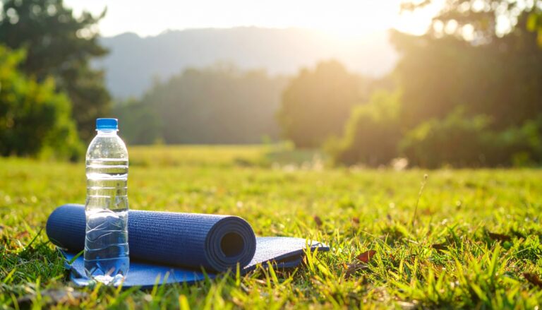 Digital detox recharge concept. Relaxing outdoor scene with a yoga mat and water bottle