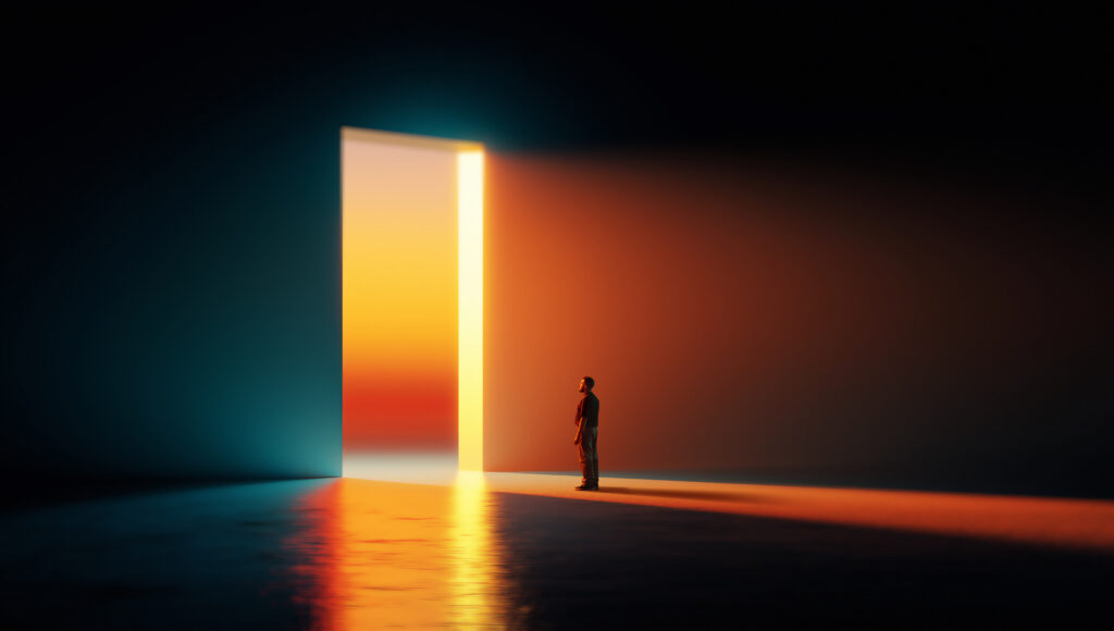 A man stands beside a tall glowing doorway emitting warm orange light in a dark room, with blue reflections on the floor.